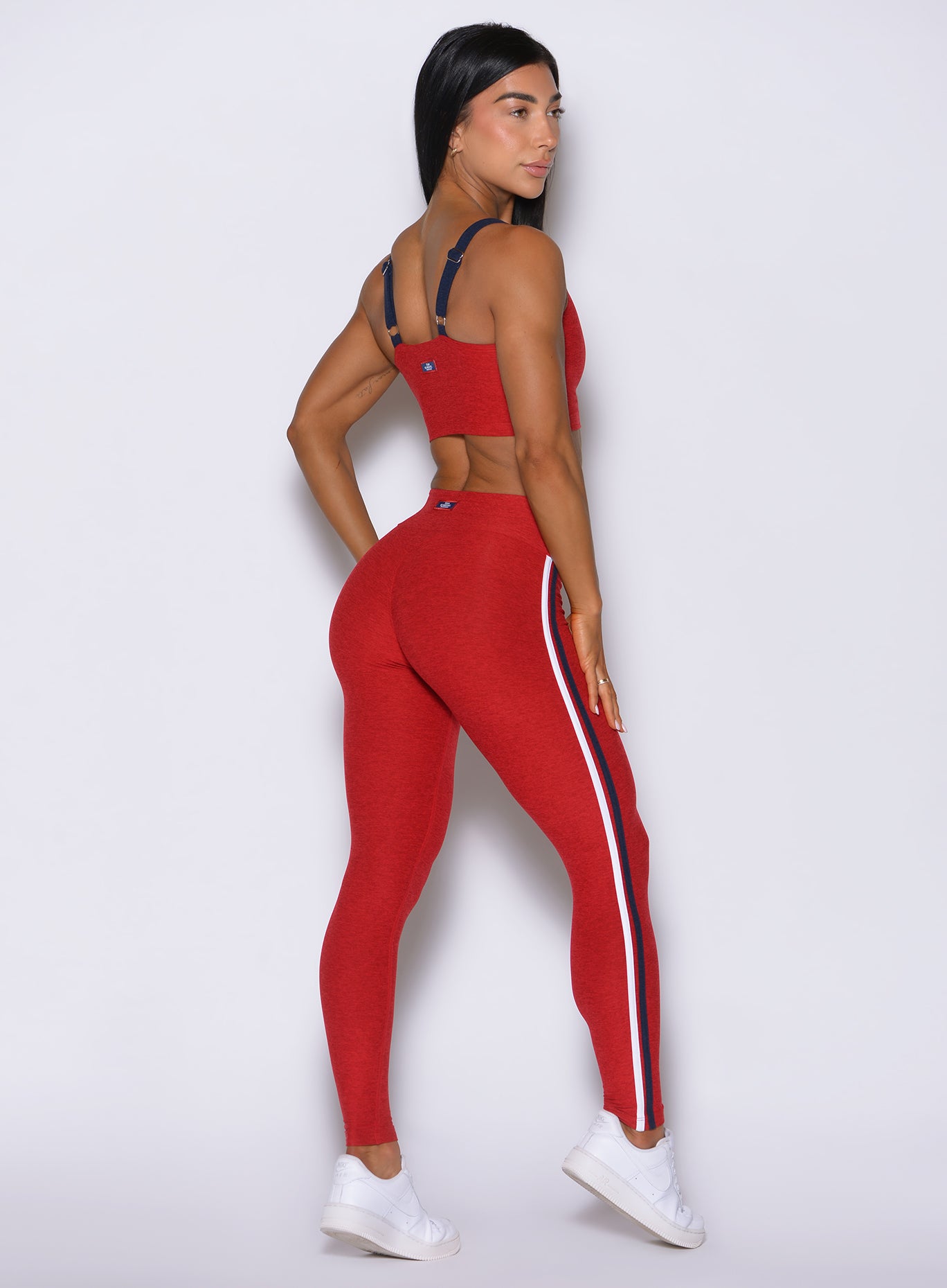 Turn-around angled shot of red Power Play leggings, detailing the instant lower-body sculpting