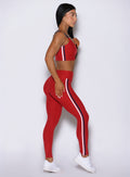 Right side of Sunset red Power Play leggings, accentuating the smooth hip-to-ankle leg elongation