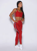 Front-right profile of Sunset red Power Play leggings, emphasizing how the stripes accentuate your curves
