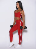 Side profile of the Sunset red Power Play leggings, highlighting a curve-enhancing, sculpting gym fit
