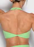 close up back profile view of a model wearing the Power Zip Tank bra in electric green color