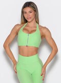 Electric Green Power Zip Tank Bra featuring a front zipper and backless twist for gym workouts.