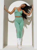 White Luxe Leg Warmers in a short, chunky rib knit style, perfect for gym and studio workouts.