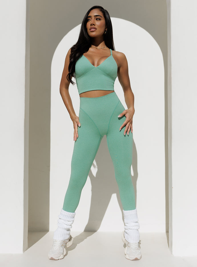 front view of a model in outdoors wearing the Electric Era Top in sage color