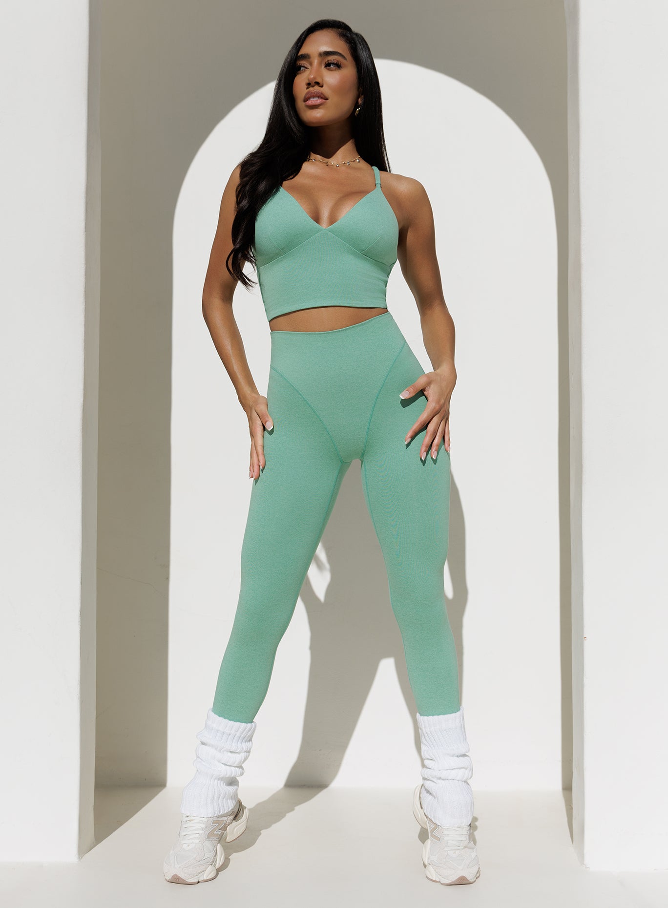 front view of a model in outdoors wearing the Electric Era Top in sage color