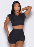front profile view of a model wearing the Core Strength Tee in Heathered Black color