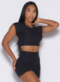 front right side profile view of a model wearing the Core Strength Tee in Heathered Black color