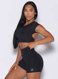 front left side profile view of a model wearing the Core Strength Tee in Heathered Black color