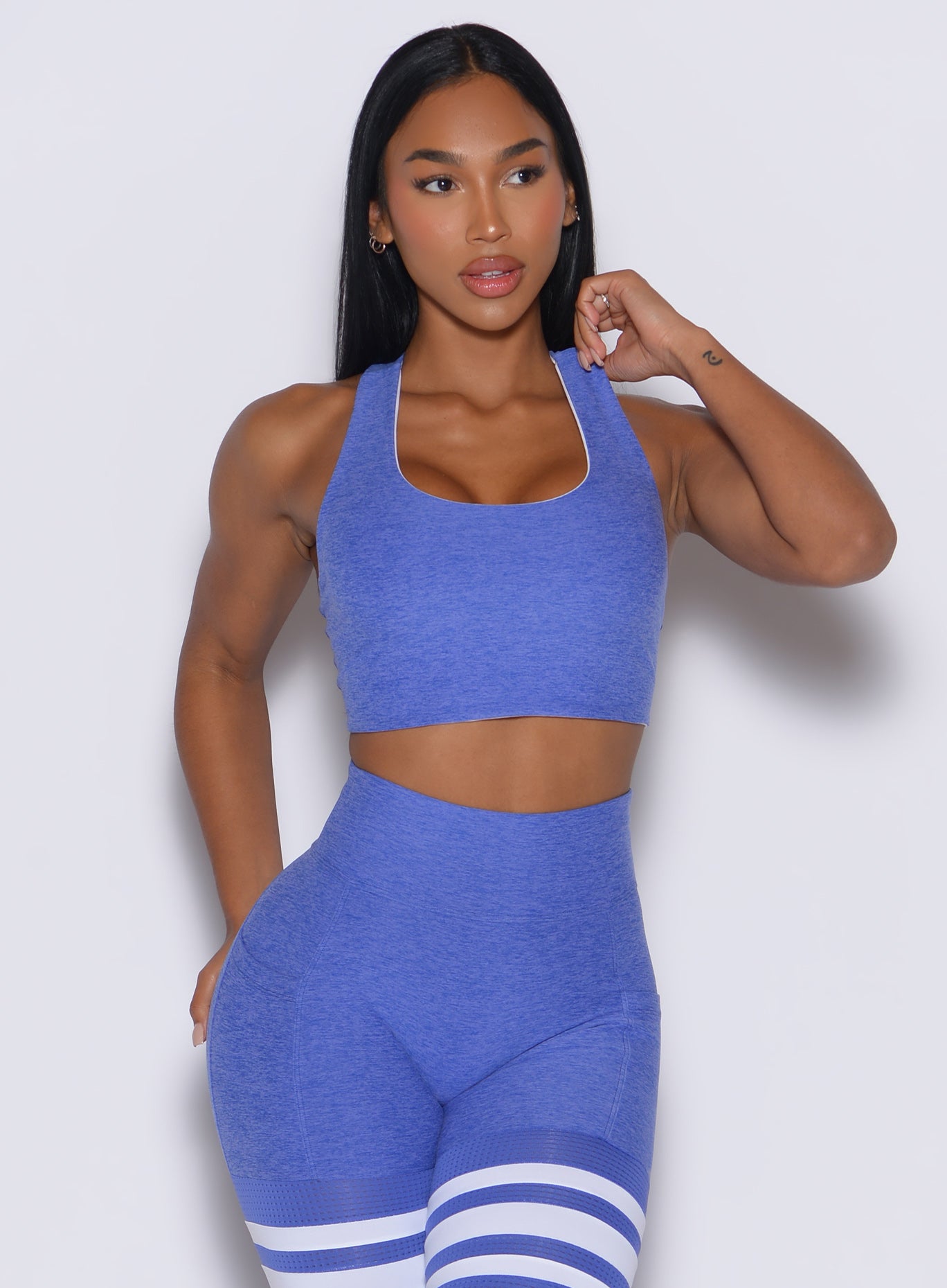 front profile view of a model wearing our reversible tank bra in Violet Blue color along with a matching thigh high leggings 