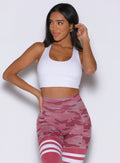 front profile view of a model looking to the right side wearing the Reversible Tank Bra in hibiscus camo