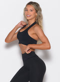 left side profile view of a model wearing the Rib Backless Bra in black color