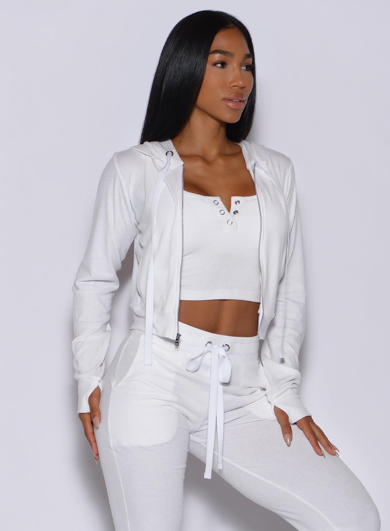 Right side profile view of a model angled right wearing our white comfort rib jacket and a matching joggers