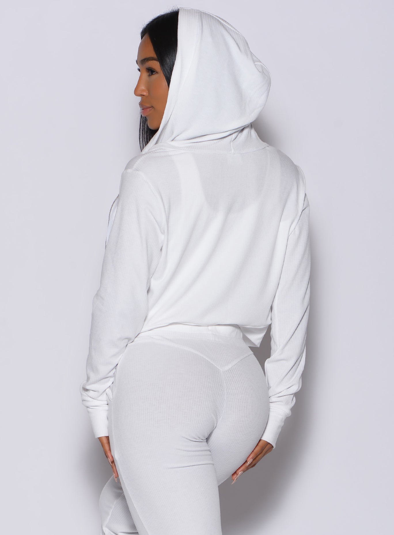 Back profile view of a model in our white comfort rib jacket and a matching joggers
