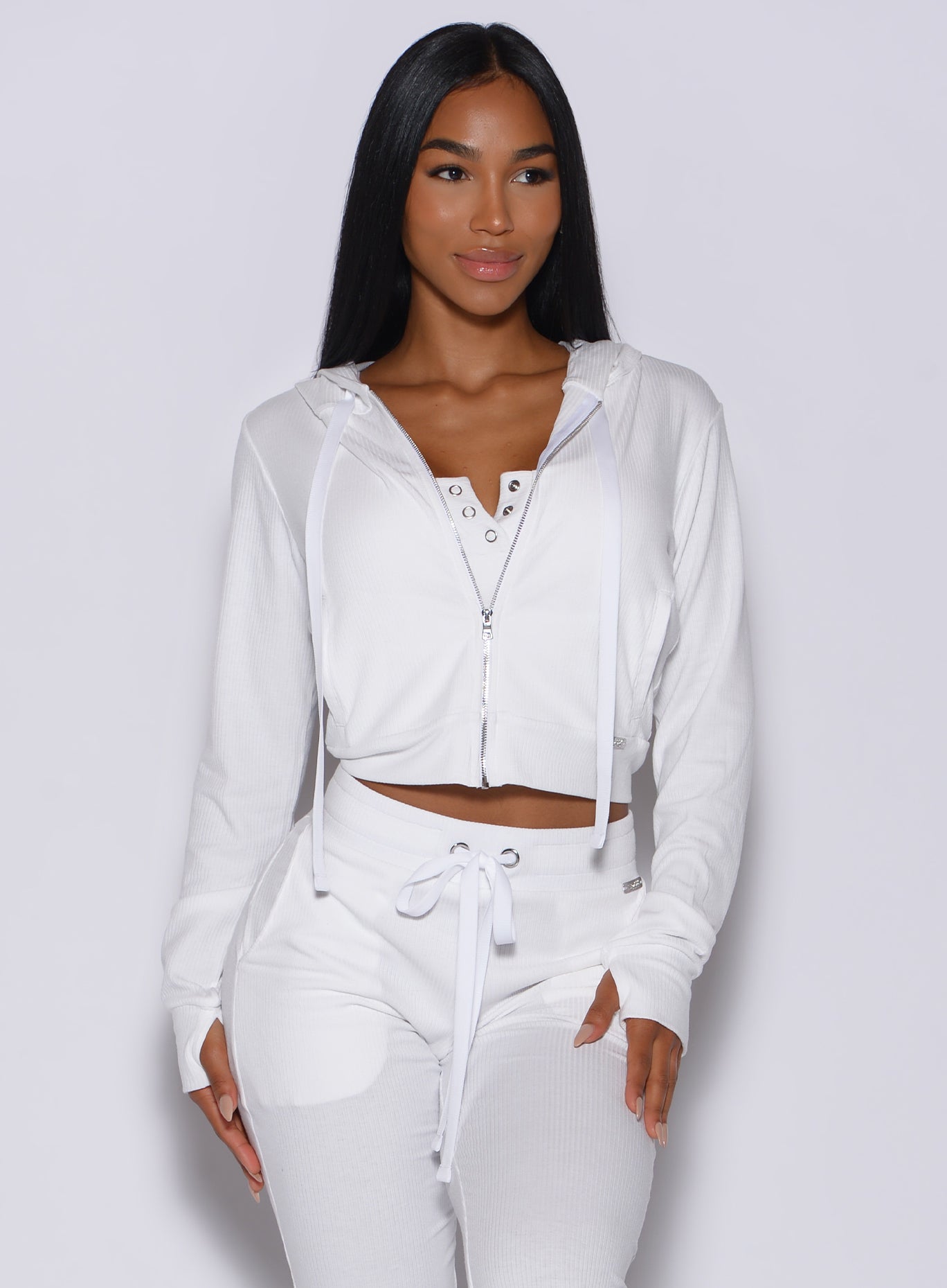 Model facing forward wearing our white comfort rib jacket along with a matching joggers 