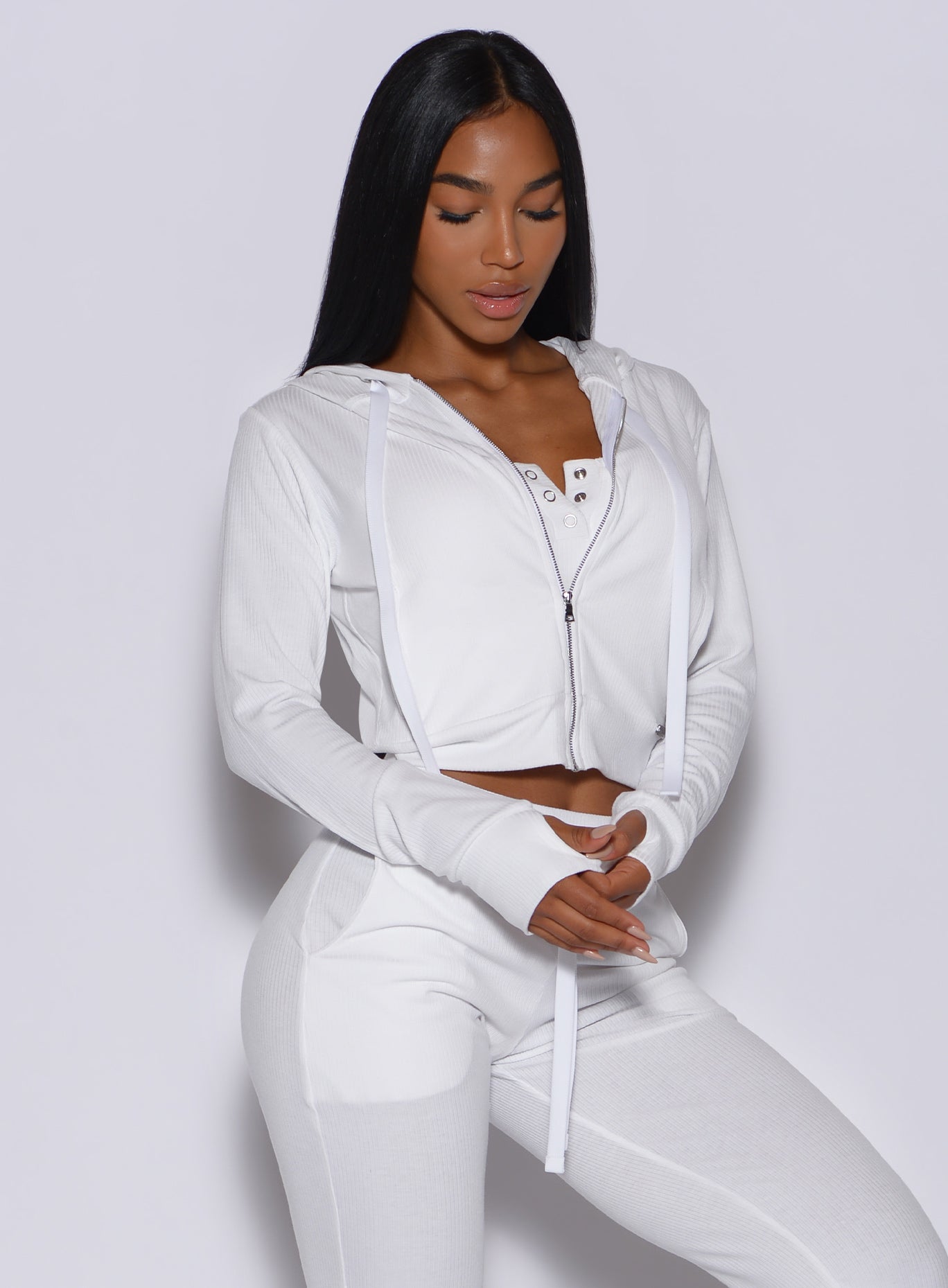picture of a model wearing our white comfort rib jacket along with a matching joggers 