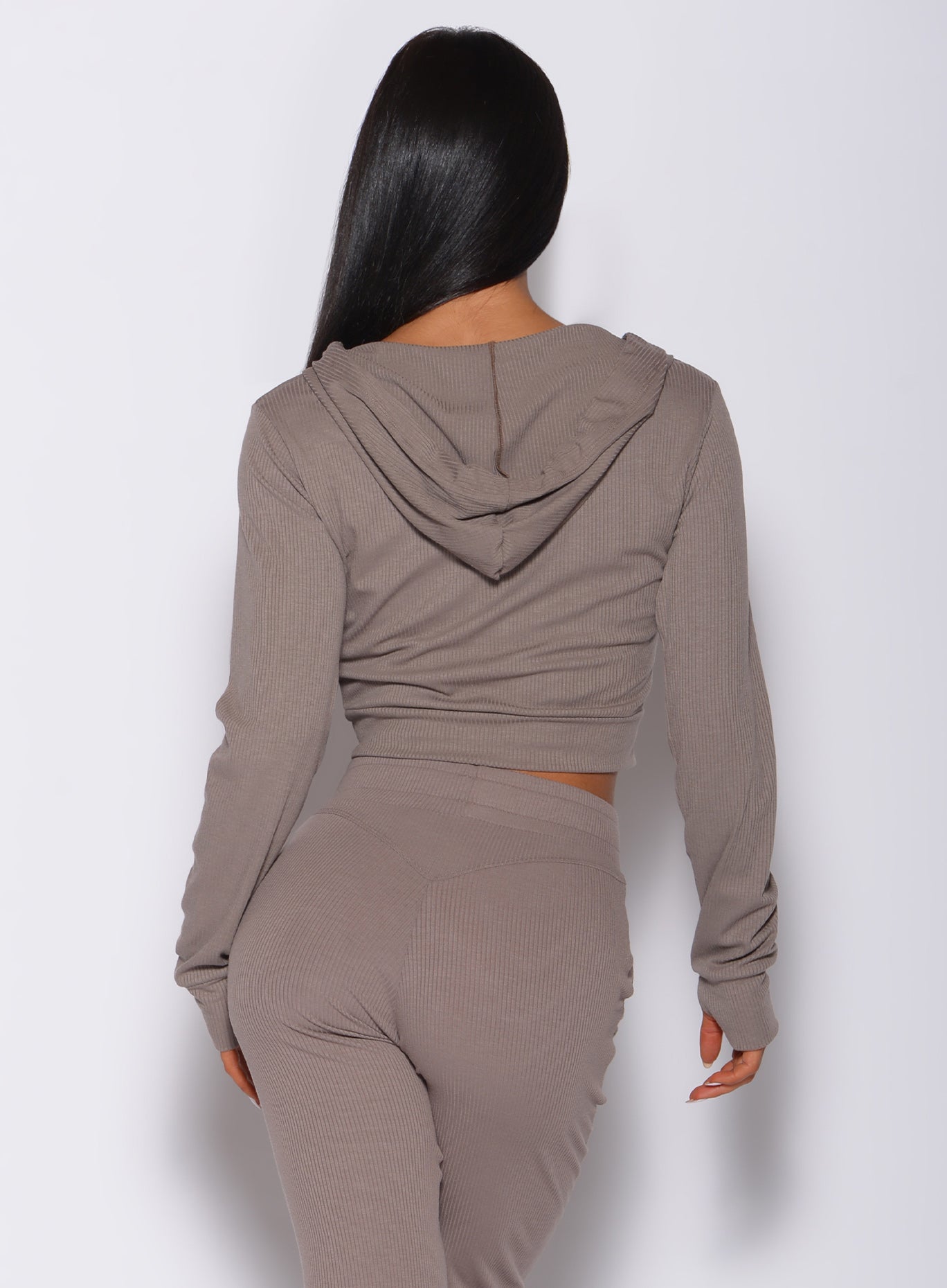 back profile view of a model in our comfort rib jacket in toffee color along with a matching joggers 