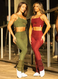 front view of a models in outdoors wearing the Luxe Leg warmers-short in Juniper and rouge color