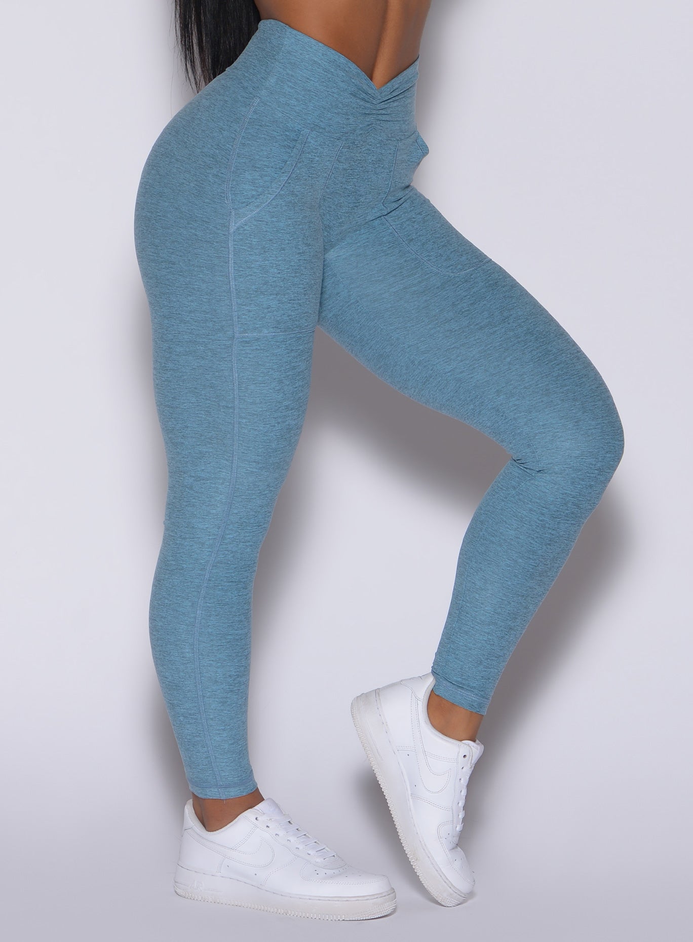 Zoomed in left side view of our V scrunch leggings in baby blue color 