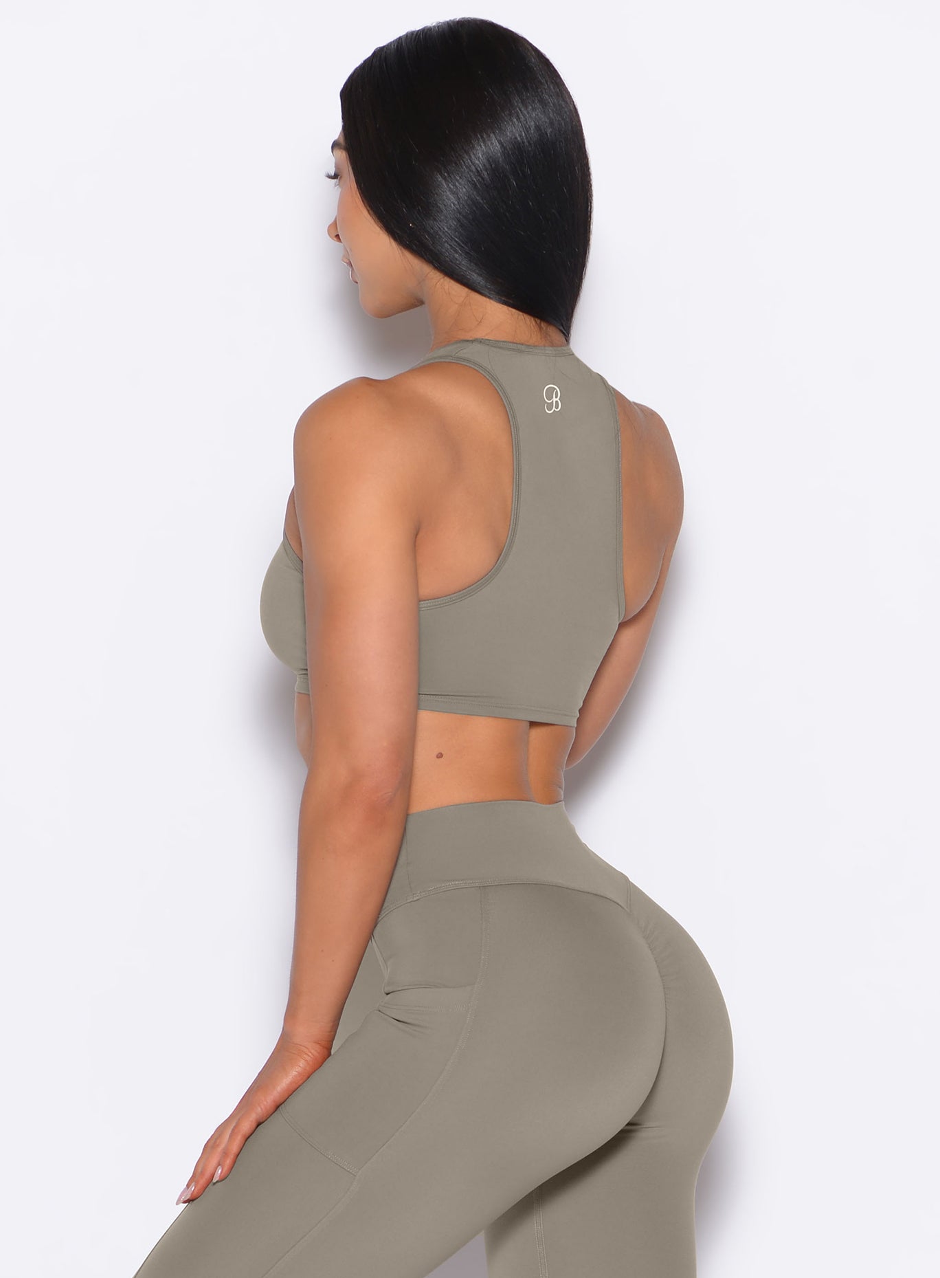 Stone Scrunch Tank Bra showing a racerback design and ruched hem for effortless, sculpted gym style.