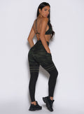 back right side profile view of a model wearing the Scrunch Thigh Highs in Green/Black camo color