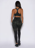 back side profile view of a model wearing the Scrunch Thigh Highs in Green/Black camo color