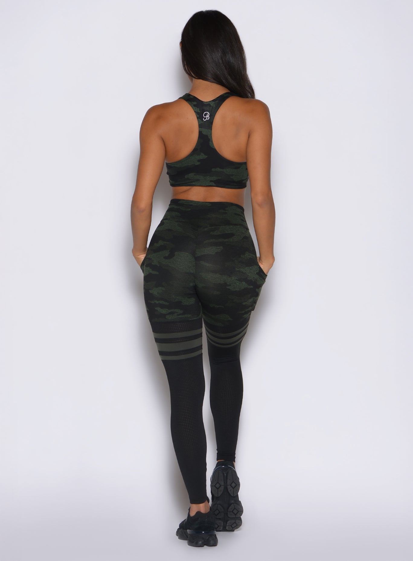 back side profile view of a model wearing the Scrunch Thigh Highs in Green/Black camo color