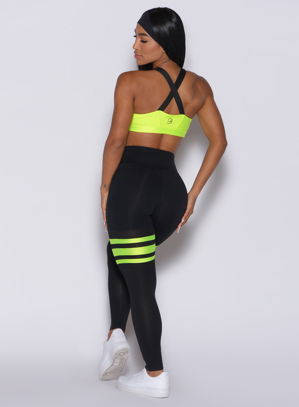 Sculpting black and neon yellow Scrunch Thigh-Highs with mesh panels for squat-proof workouts.