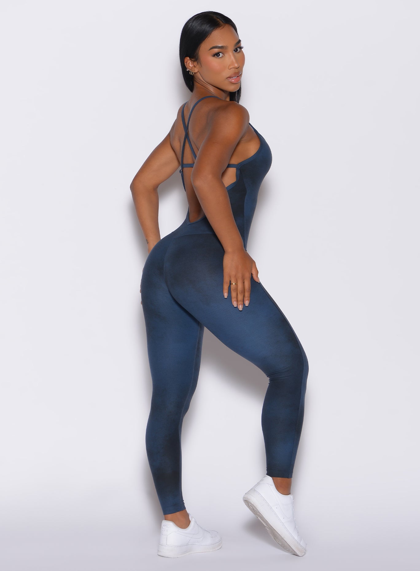Right side profile view of a model in our Sculpt Bodysuit in Vintage blue color