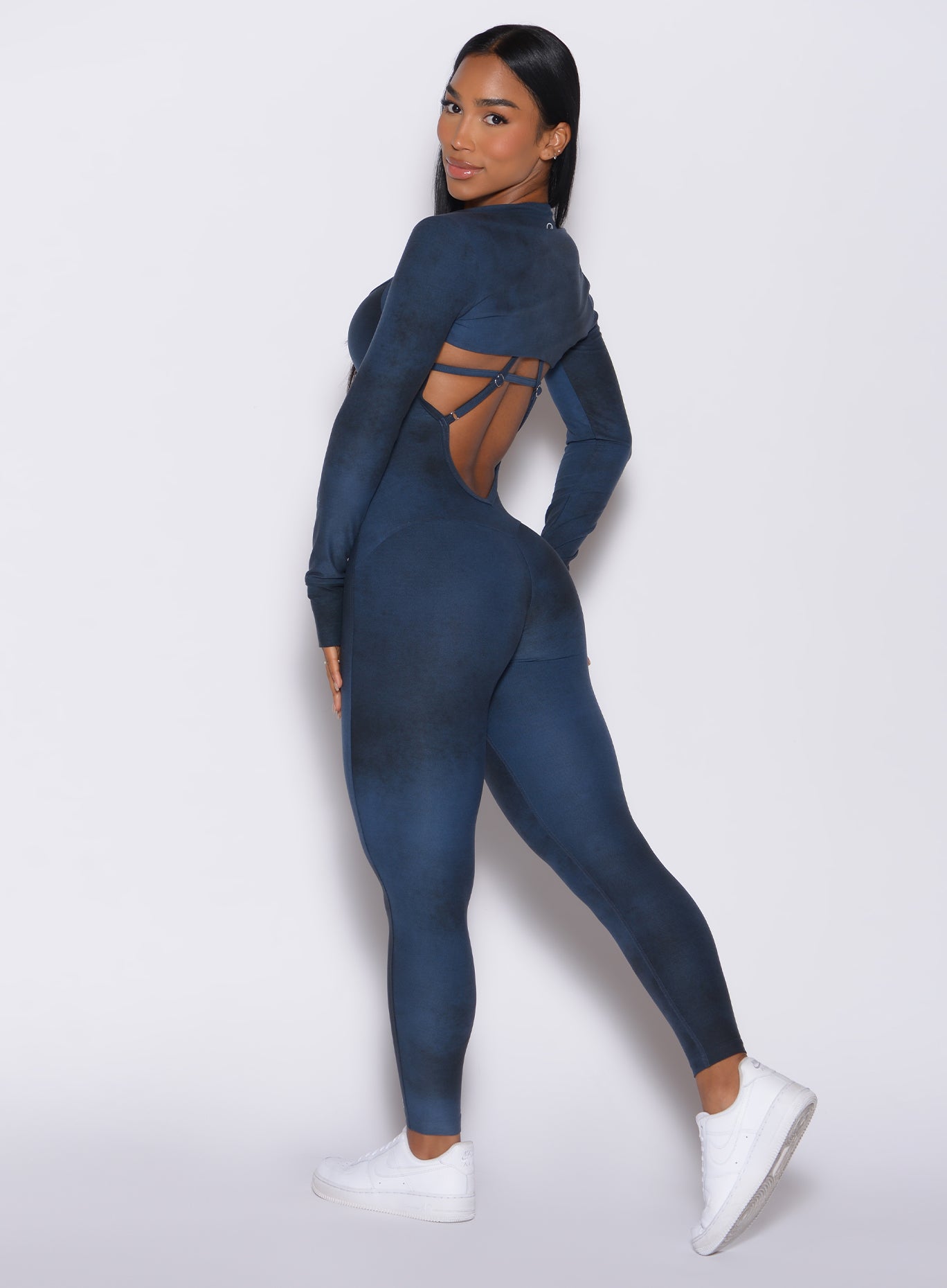 Left side profile view of a model in our Sculpt Bodysuit in Vintage blue color along with the matching shape shrug