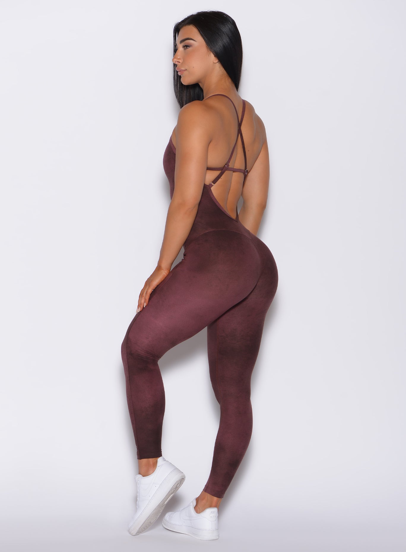 Left side profile view of a model in our Sculpt Bodysuit in Vintage Port color