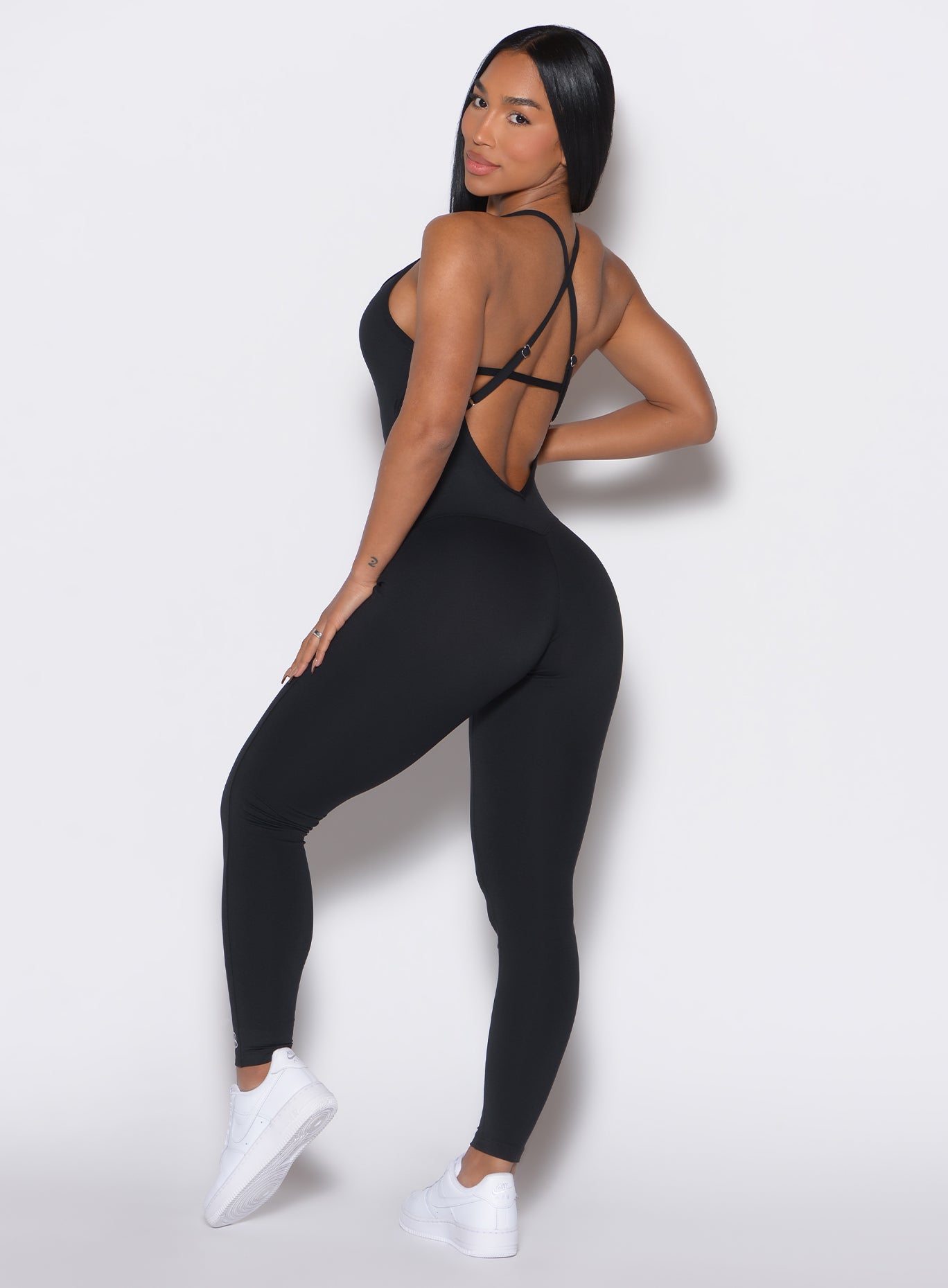 Black Sculpt Bodysuit with open back and V-tapered seams for a contoured gym silhouette.