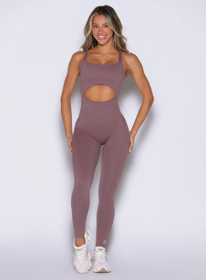 Mauve Sculptura Bodysuit with contouring seams and bold cutouts for a high-performance gym look.