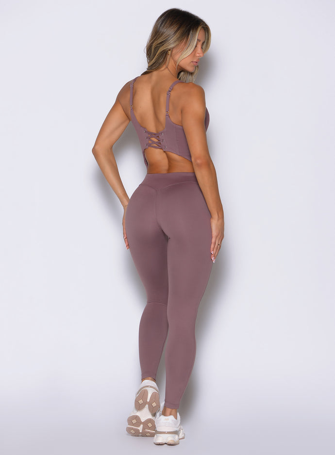 Mauve Sculptura Bodysuit with a stylish lace-up back and sculpting seams for high-impact training.