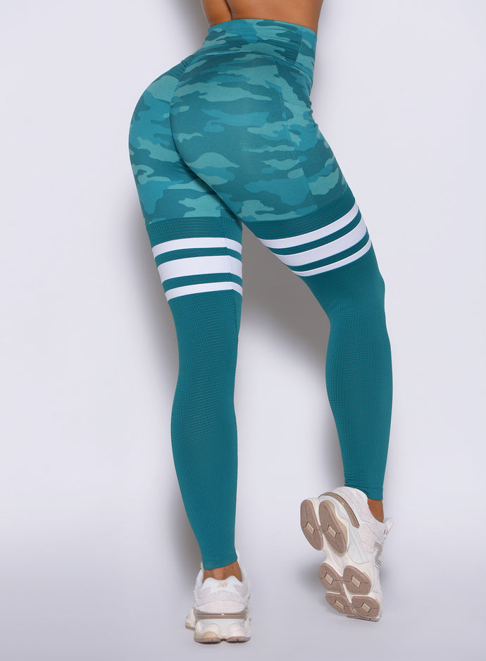 close up back side view of a model wearing the Scrunch Thigh Highs in Teal camo color