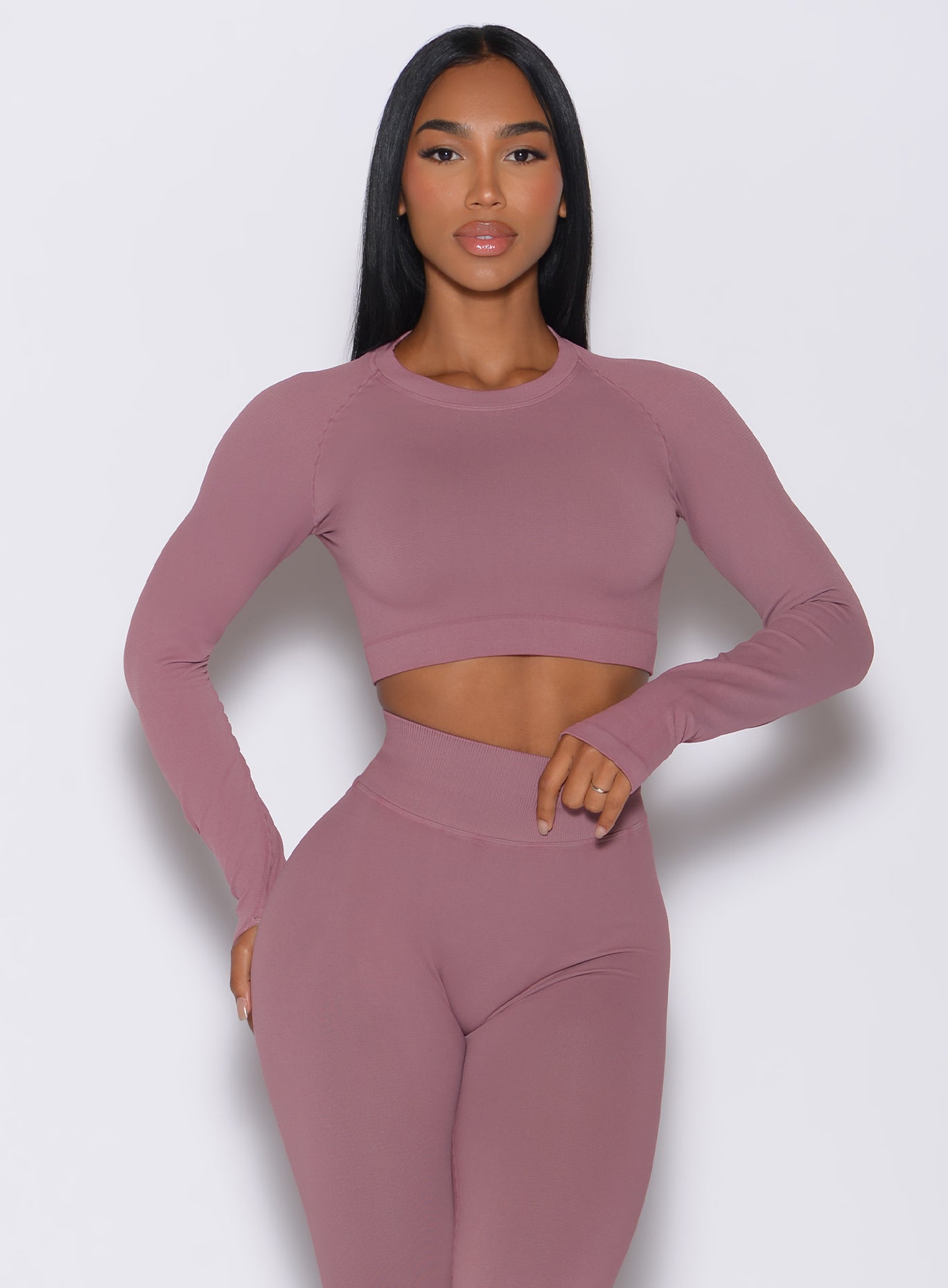 front profile view of a model angled right in our seamless pullover in satin color along with a matching leggings