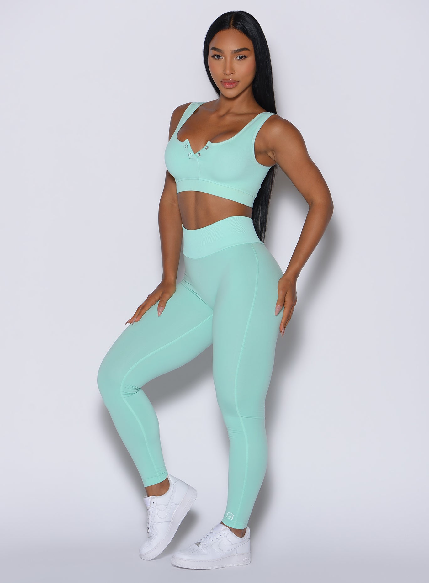 Front-left profile of Spring Mint Figure Leggings featuring a snatched, seamless ribbed waistband.