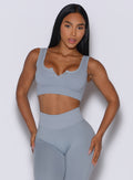 Model facing forward wearing our Snap Seamless Bra and the matching leggings in Carbon color