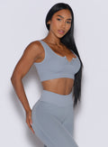 Right side view of a model wearing our Snap Seamless Bra and the matching leggings in Carbon color