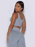 back profile of a model wearing the Snap Seamless Bra and the matching leggings in Carbon color