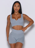 front profile view of a model wearing our Snap Seamless Bra and the matching shorts in Carbon color