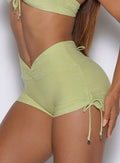 a close up view of a model from the left side wearing the Charm Fit shorts in serpentine color