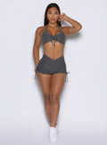 frontal view of a model wearing the Charm Fit shorts in steel shadow color