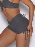 close up left side view of a model wearing the Charm Fit shorts in steel shadow color