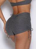 close up back profile view of a model wearing the Charm Fit shorts in steel shadow color
