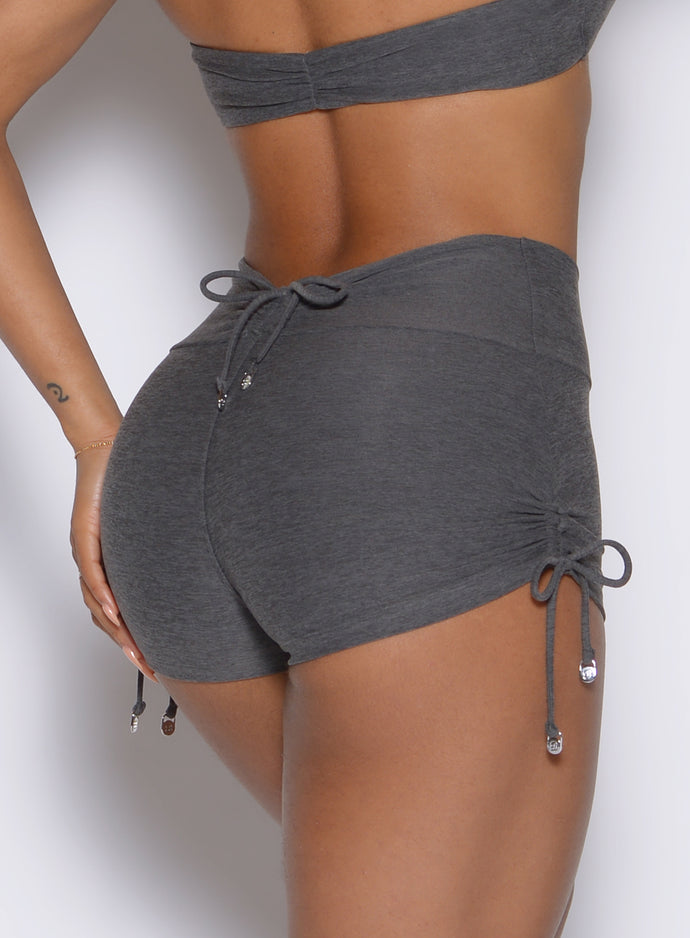 close up back profile view of a model wearing the Charm Fit shorts in steel shadow color