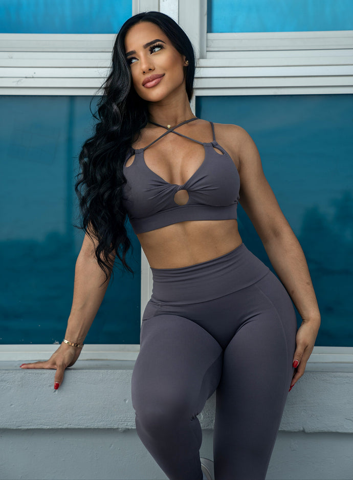 Front profile view of a model looking to her right side wearing our new shape leggings and a matching sports bra