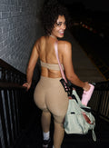back profile view of a model wearing the Dual Charm Bra in sandstone color