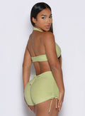right side profile view of a model looking over her shoulder wearing the Dual Charm Bra in serpentine color