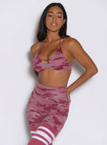 front profile view of a model wearing the She owns it Bra in hibiscus camo paired with the matching leggings