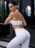 Model in outdoors wearing the Shimmer V Back Leggings in White star color